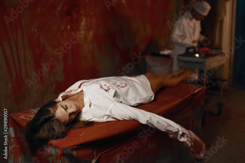 Bloodied body of female patient, doctor maniac
