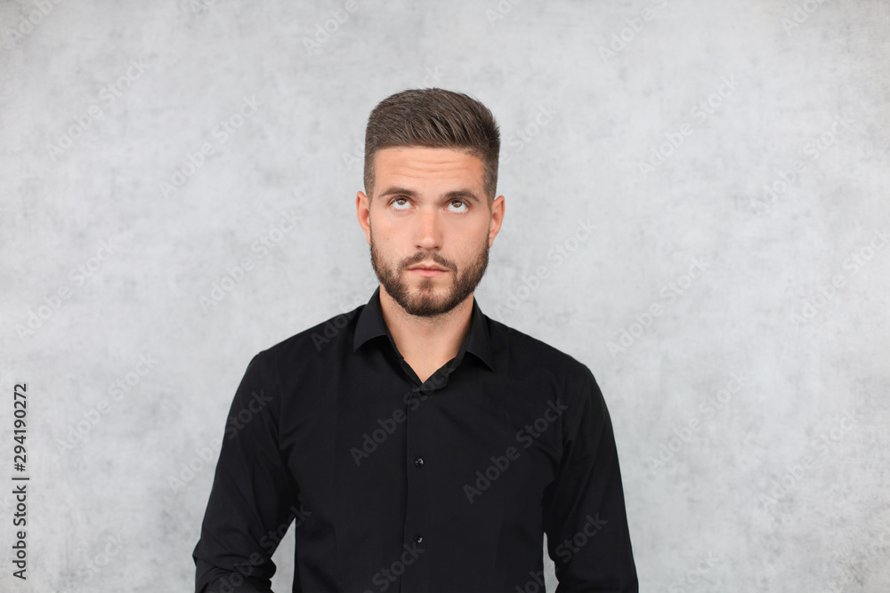 Portrait of happy fashionable handsome man in black shirt looking at camera