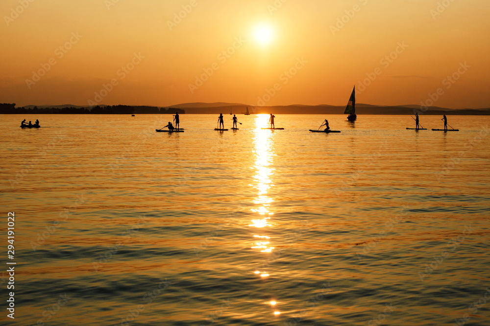 Silhouette Of surfer people on sunset beach. Vacation on sea theme. Silhouette Of surfer people on sunset beach. Vacation on sea theme.