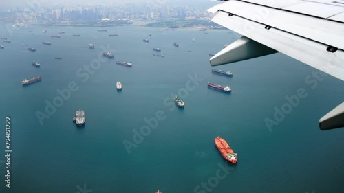 Traveling by air. View singapore bay through an airplane window. Airplane is about to land in Singapore airport photo