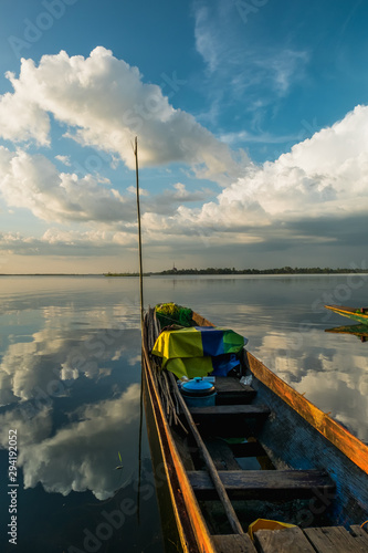 boat on the lake against bueutiful cloudy sky,nong han river view in sakon nakhon province,thailand photo