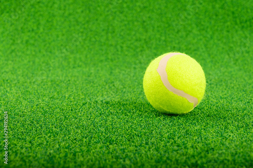 Tennis ball put on the green grass © Vatcharachai