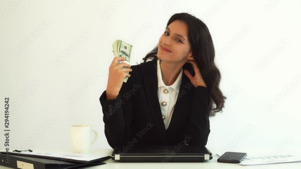 Businesswoman hold us dollar money. Working woman can earn a lot of money. Beautiful young lady get happiness, counting a lot of money at office or her company with dancing. Millionaire girl get proud Businesswoman hold us dollar money. Working woman can earn a lot of money. Beautiful young lady get happiness, counting a lot of money at office or her company with dancing. Millionaire girl get proud
