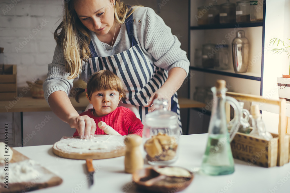 Happy family in the kitchen. Mother and daughter are preparing the christmas cookies. Happy family in the kitchen. Mother and daughter are preparing the christmas cookies.