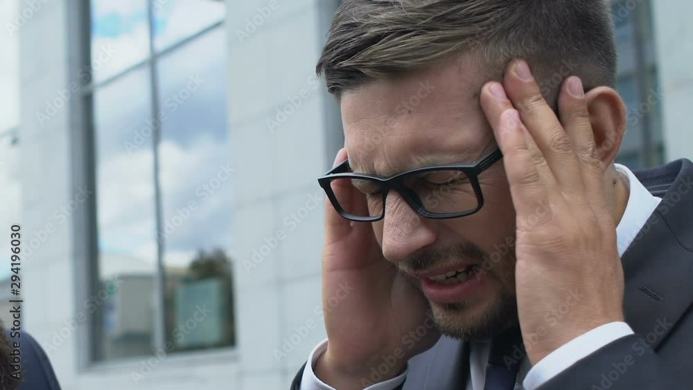 Colleague supporting business partner suffering migraine pain, stressful life Colleague supporting business partner suffering migraine pain, stressful life