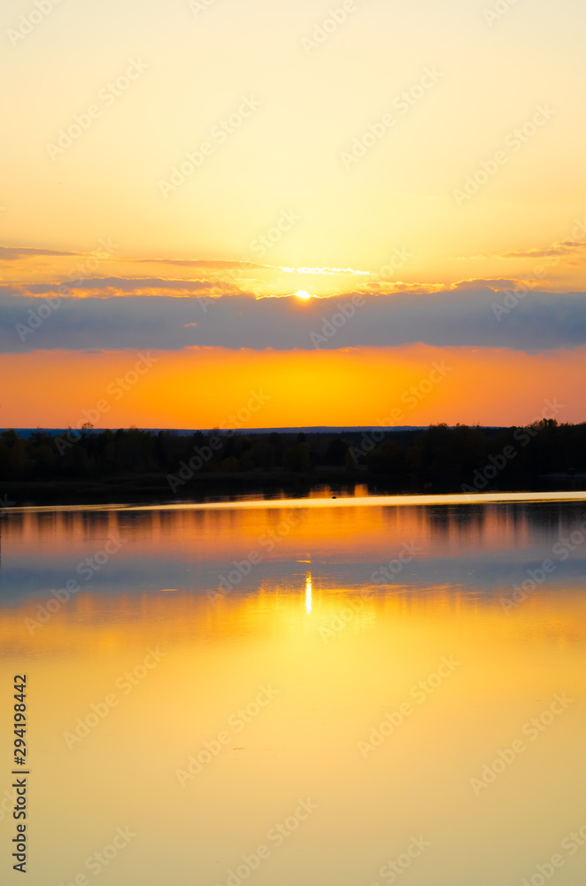 orange sunset on a blue lake