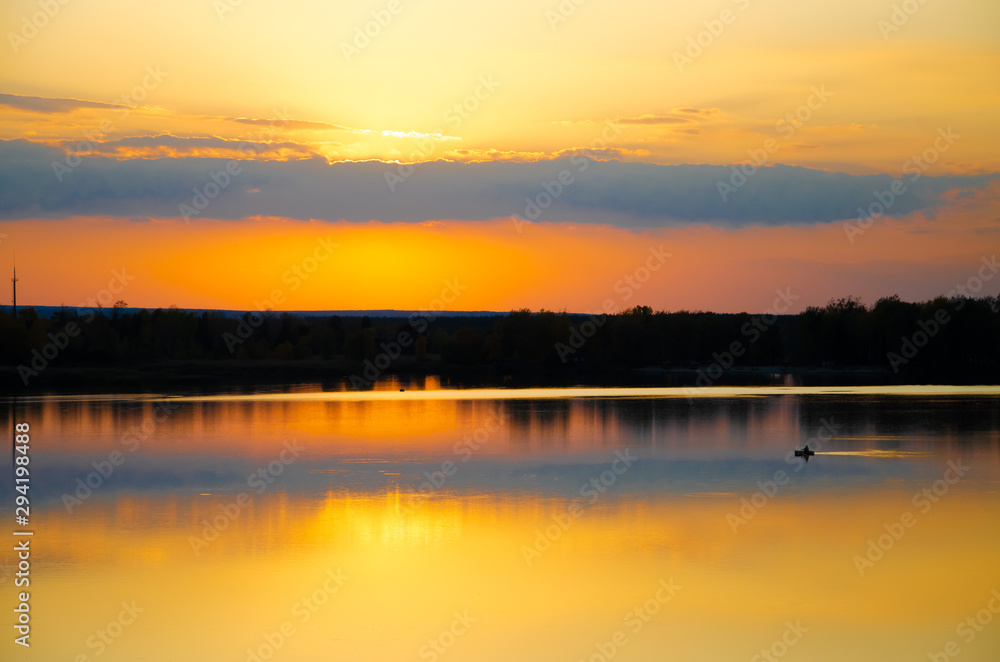 orange sunset on a blue lake