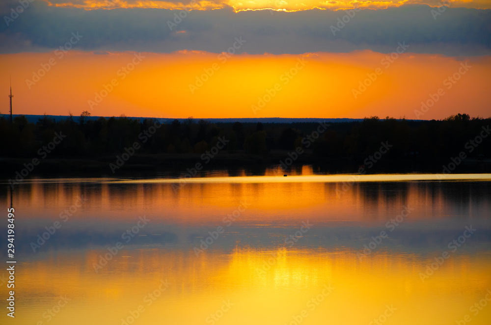 orange sunset on a blue lake