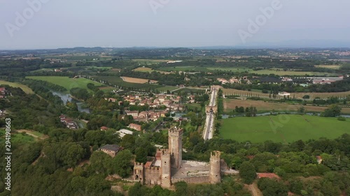 Wallpaper Mural Castello scaligero in the town of Valeggio sul Mincio. The historic Ponte Visconteo Bridge was built in 1395 on the Mincio River. Aerial view. Flying on drone.  Torontodigital.ca