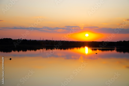 orange sunset on a blue lake