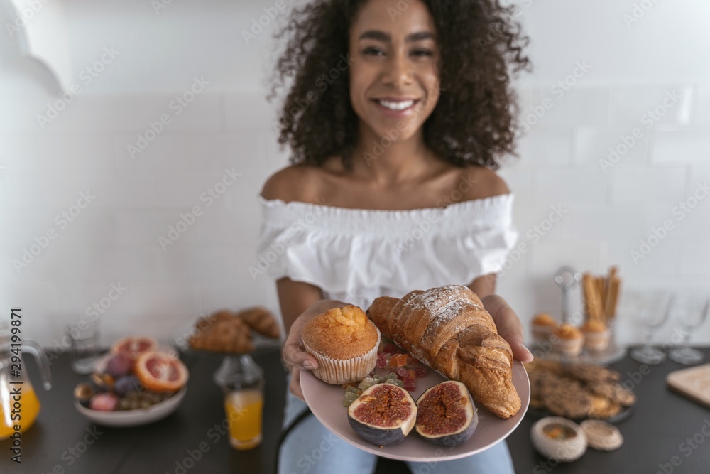 Smiling woman sharing her food with a friend Smiling woman sharing her food with a friend