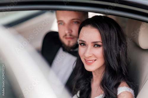 close up. a happy couple of newlyweds sitting in the car. © yurolaitsalbert