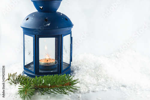 Beautiful Christmas holiday background with burnign candle on the white background