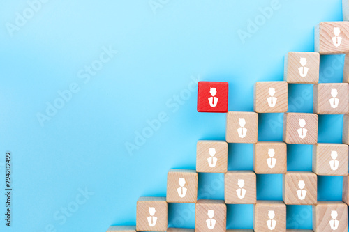 Red wooden block with businessman icon stand out from the crowd, Leadership, dissenting opinion, divergent views and different concepts, copy space