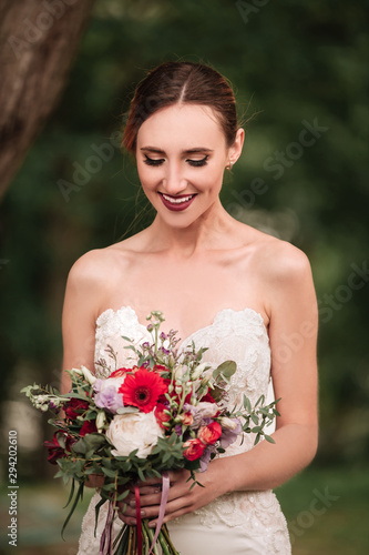 beautiful bride in a wedding dress and a wedding bouquet