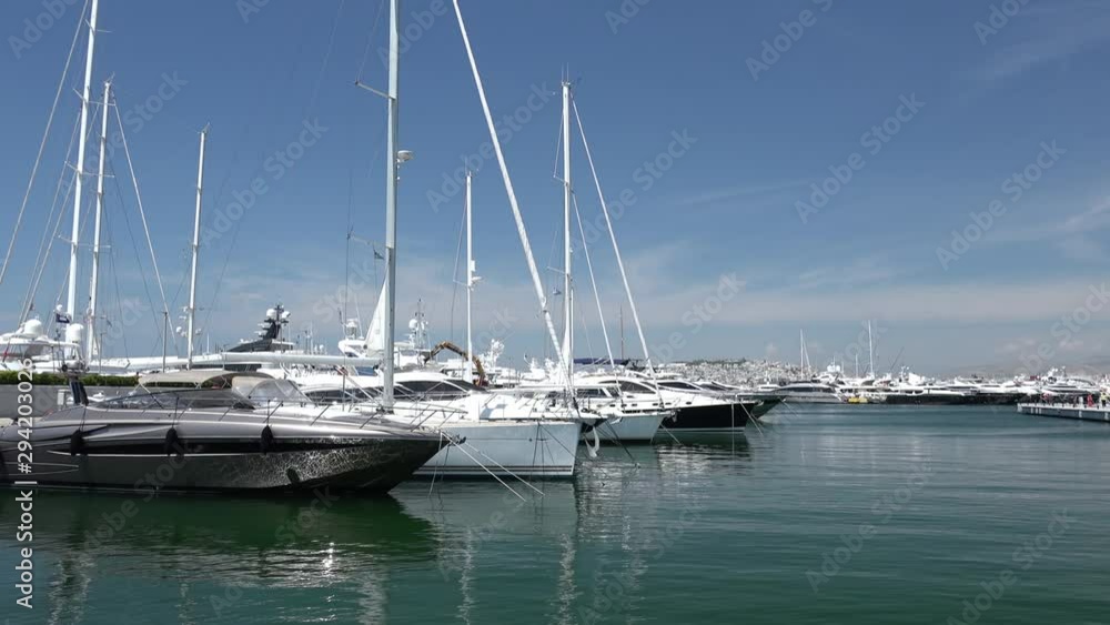 Peaceful panorama of Yacht club in Athens. Luxury relaxation in Flisvos Marina. Amazing Aegean sea promenade. Beauty of mediterranean nature and azure water. Popular touristic attraction in Greece Peaceful panorama of Yacht club in Athens. Luxury relaxation in Flisvos Marina. Amazing Aegean sea promenade. Beauty of mediterranean nature and azure water. Popular touristic attraction in Greece