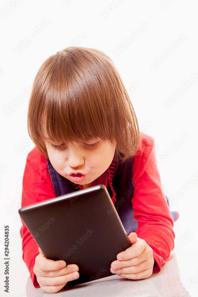 Concept of good and successful management and planing of day. Humorous photo of cute little child girl with tablet. Concept of good and successful management and planing of day. Humorous photo of cute little child girl with tablet.