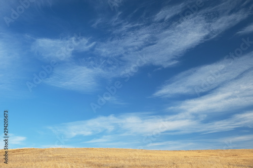 autumn steppe and blue sky with cloudy clouds