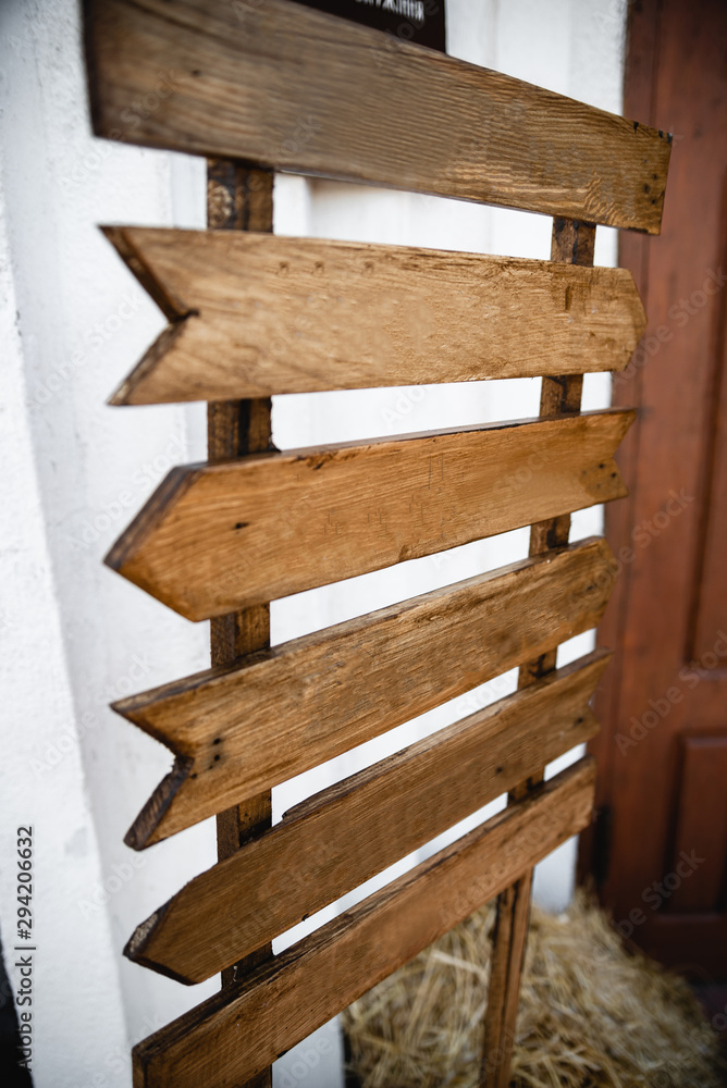 Wedding wood decoration. Copyspace on wooden board. Wooden table decorated by flowers and greenery and lounge zone. Wedding photo zone. Party zone rustic style. Wedding wood decoration. Copyspace on wooden board. Wooden table decorated by flowers and greenery and lounge zone. Wedding photo zone. Party zone rustic style.