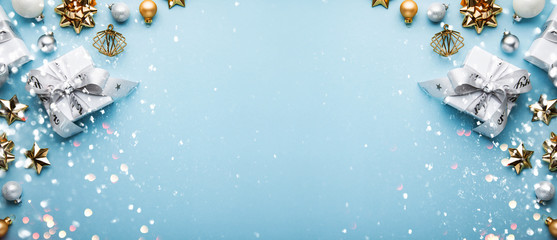 Christmas and New Year holiday background. Xmas greeting card. Christmas gifts on blue background top view. Flat lay