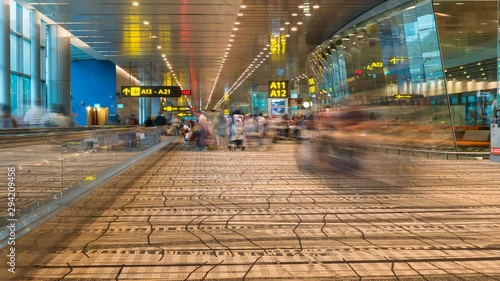 Changi airport, Singapore City, Singapore - February 12, 2017: Time lapse footage of passengers, crowd and people in Changi international airport in Singapore, the largest airport in Singapore photo