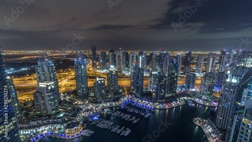 Wallpaper Mural Dubai Marina illuminated skyscrapers and jumeirah lake towers panoramic view from the top aerial all night timelapse with lights swithcing off in the United Arab Emirates. Traffic on a road and Torontodigital.ca