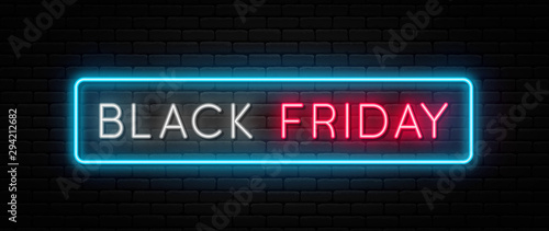Black Friday sale. Black Friday neon sign on brick wall background. Glowing white and red neon text in blue frame for advertising and promotion. Banner and background, brochure and flyer design