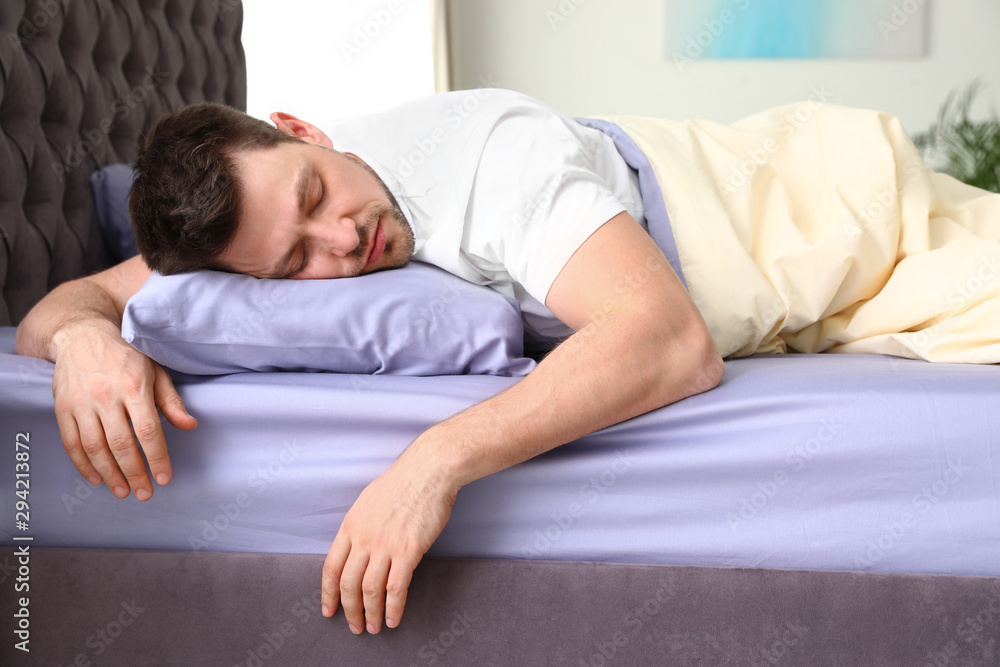 Handsome man sleeping on pillow at home. Bedtime Handsome man sleeping on pillow at home. Bedtime