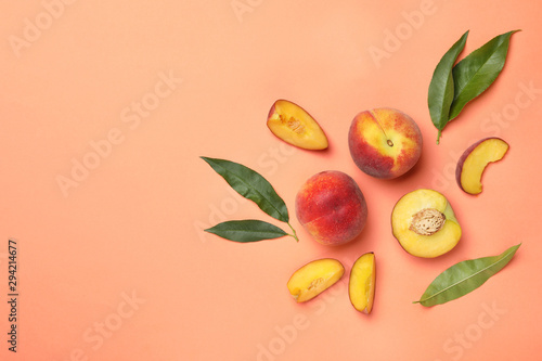 Flat lay composition with sweet juicy peaches and space for text on orange background