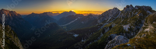 Panorama of the Julian Alps at sunset from the Mangart peak, the Triglav peak visible in the central part of the frame photo