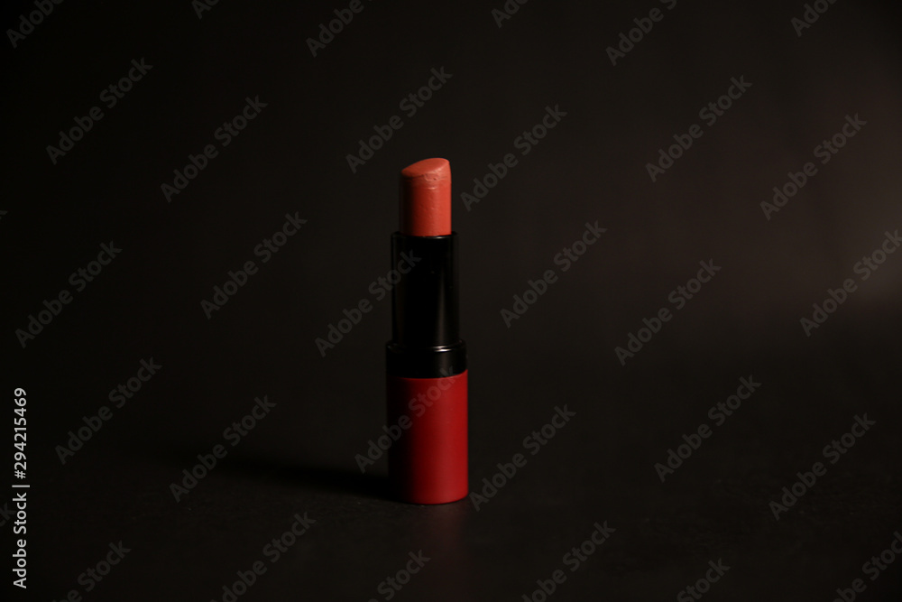 Red matt lipstick isolated on black background with reflection. New open velvet satin airy lip stick with cap. Red matt lipstick isolated on black background with reflection. New open velvet satin airy lip stick with cap.