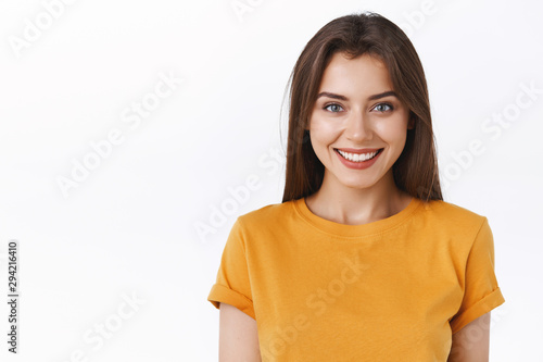 Obraz na płótnie Close-up alluring happy smiling brunette woman in yellow t-shirt looking forward