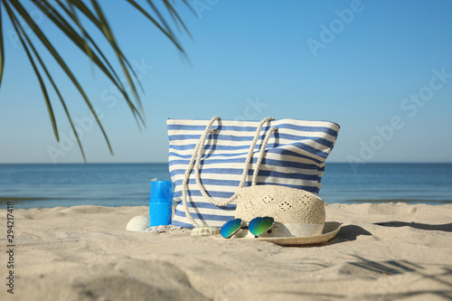 Stylish beach accessories on sandy sea shore