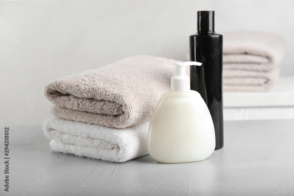 Fresh towels and toiletries on light grey stone table Fresh towels and toiletries on light grey stone table