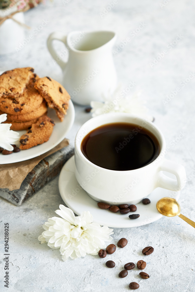 Cup of black strong coffee with coffee beans and cookies on white background Cup of black strong coffee with coffee beans and cookies on white background