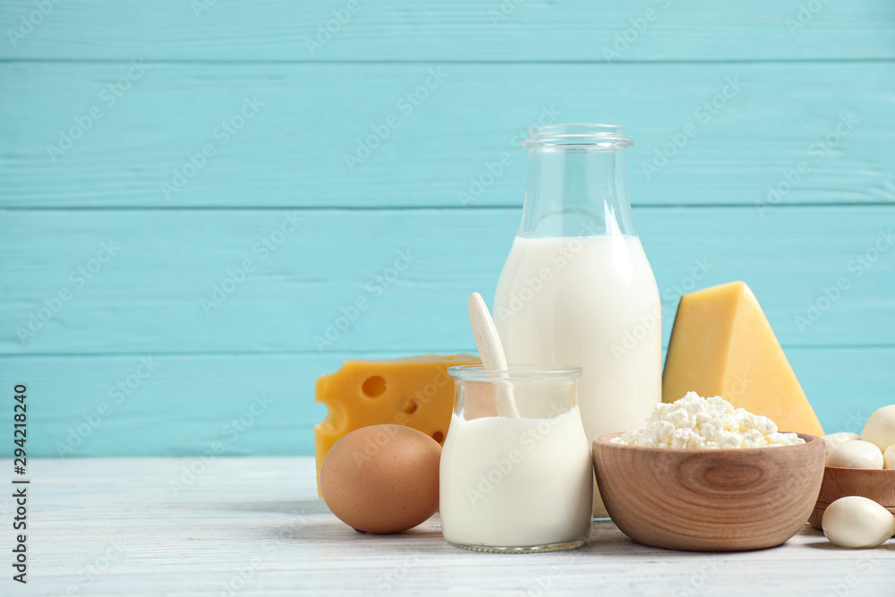 Different dairy products on white table against blue background. Space for text Different dairy products on white table against blue background. Space for text