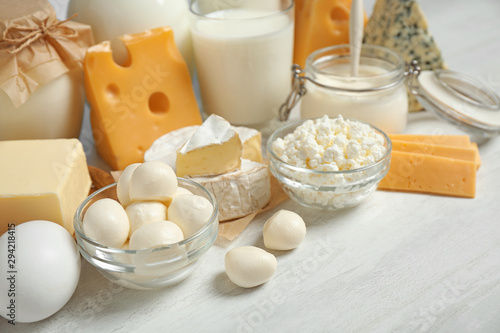 Different delicious dairy products on white table