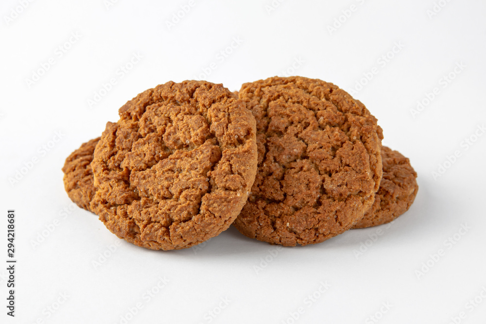 Tasty crunchy cookie: oatmeal, shortbread, chocolate, nutty, honey. Close-up isolated on a white background Tasty crunchy cookie: oatmeal, shortbread, chocolate, nutty, honey. Close-up isolated on a white background