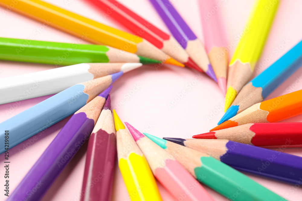 Composition with color pencils on pink background, closeup Composition with color pencils on pink background, closeup