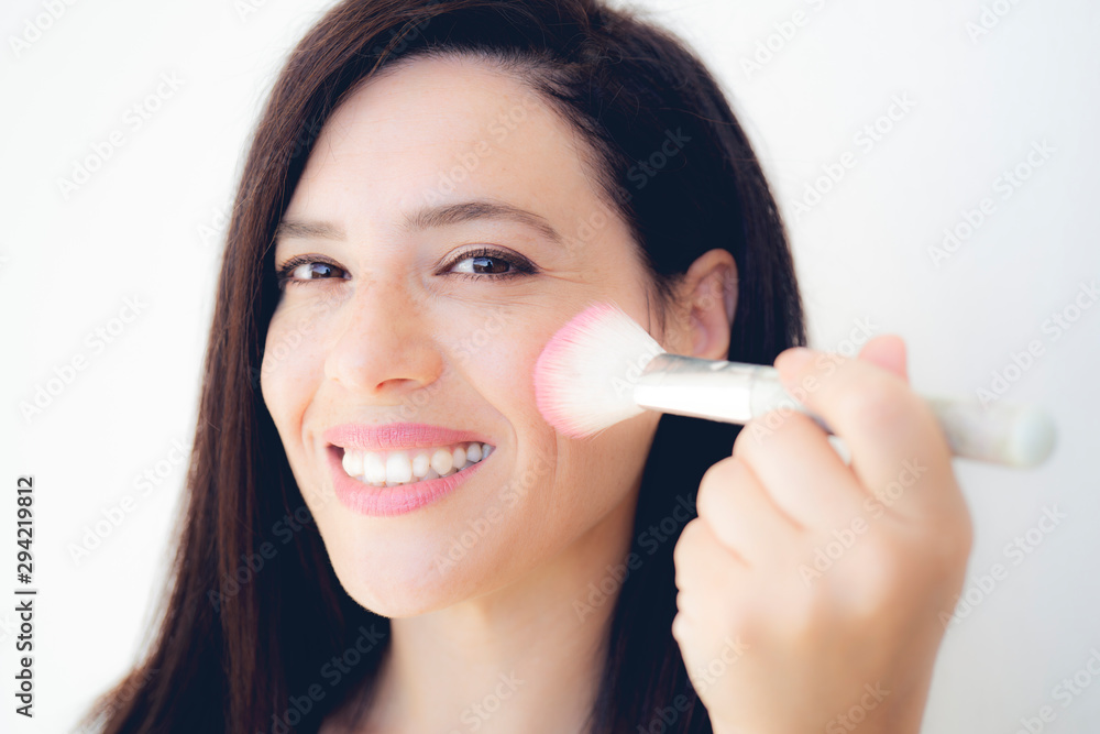 Beautiful girl with cosmetic powder brush for make up. Makeup. Make-up applying for perfect skin. Beautiful girl with cosmetic powder brush for make up. Makeup. Make-up applying for perfect skin.