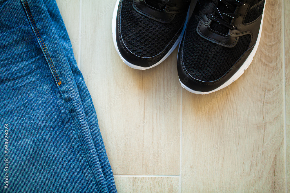 Jeans and black sneakers on the store shelf. Jeans and black sneakers on the store shelf.