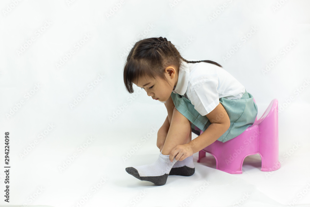Little kid practice put on the socks and shoes to dressing by herself. Learning to do activity daily living help the kids developt their self esteem and confident. Little kid practice put on the socks and shoes to dressing by herself. Learning to do activity daily living help the kids developt their self esteem and confident.