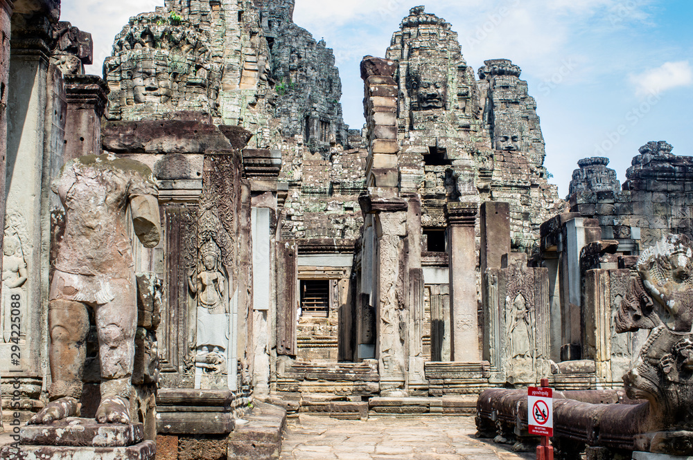 Siem Reap / Cambodia - May 27 / 2019 : entrance of bayon temple with huge buddha heads at angkor wat temple complex