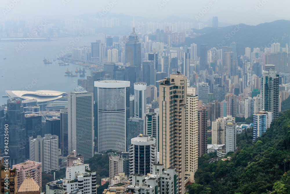 View on Skyscraper Panorama with Victoria Bay, Transportation Ships, Harbour and Kowloon taken from Hongkong Island Peak. Hong Kong, China