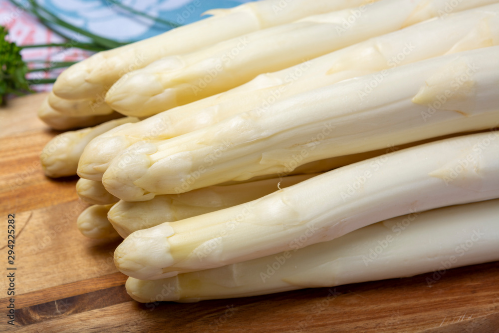 Bunch of fresh uncooked white asparagus and boiled eggs, new harvest Bunch of fresh uncooked white asparagus and boiled eggs, new harvest
