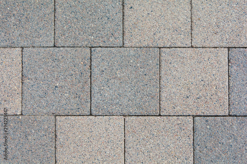 wall built of square granite slabs of different colors