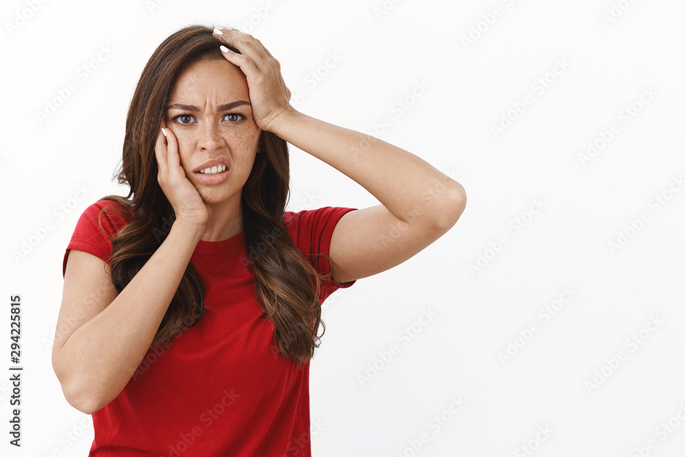 Waist-up shot embarrassed hopeless young brunette woman in red casual t-shirt grab head, frowning upset and cringe from disappointment, losing competition feeling frustration and sadness Waist-up shot embarrassed hopeless young brunette woman in red casual t-shirt grab head, frowning upset and cringe from disappointment, losing competition feeling frustration and sadness