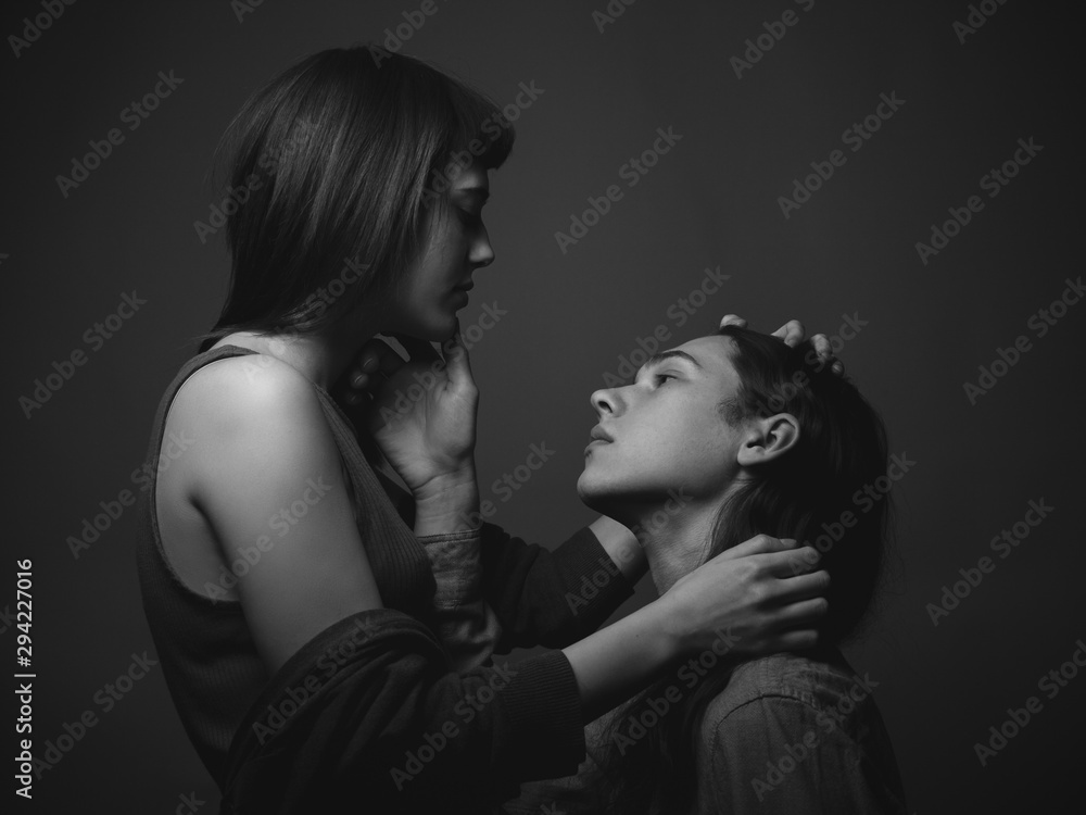 Young man and girl caress each other. Couple in love. Black and white