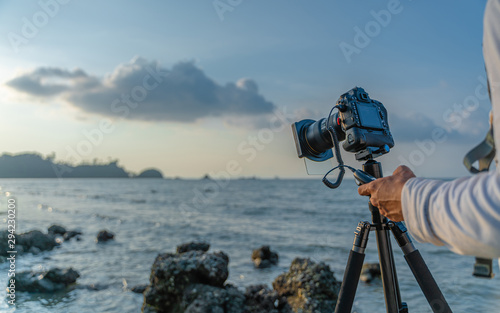 Camera With Tripod And Sea Scenery
