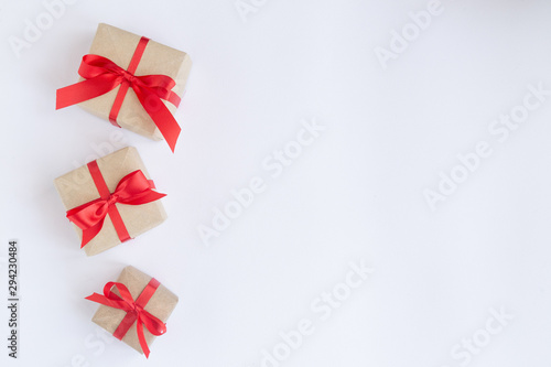 brown gift box with red ribbon on white background top view for christmas or celebrate